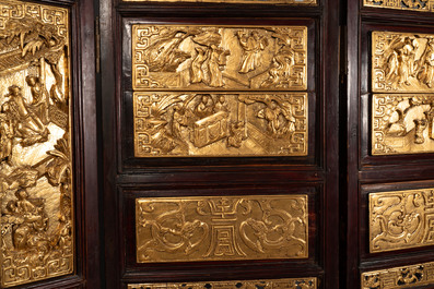 A Chinese four-part reticulated and partially gilt wooden folding screen, 19th C.