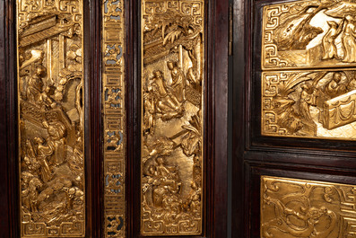 A Chinese four-part reticulated and partially gilt wooden folding screen, 19th C.