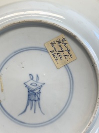 A pair of Chinese famille verte plates with figures along the riverside, artemisia leaf and ding mark, Kangxi