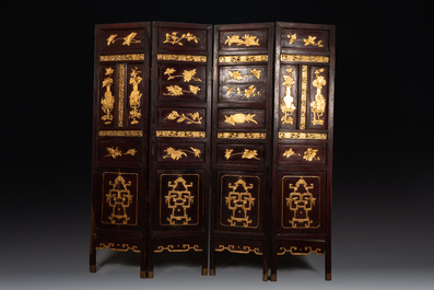 A Chinese four-part reticulated and partially gilt wooden folding screen, 19th C.