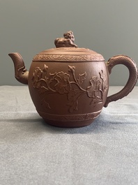 A Chinese Yixing stoneware teapot with relief design, Kangxi