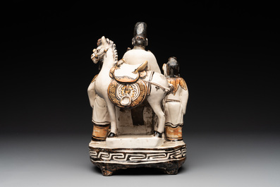 A rare Chinese Cizhou group with a dignitary, two attendants and a horse, Ming