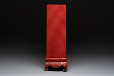 A Chinese cinnabar lacquer 'mountainous landscape' cabinet on a stand, 19th C.