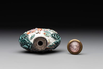 A Chinese famille rose relief-molded snuff bottle with an animated river landscape, Jiaqing mark and of the period