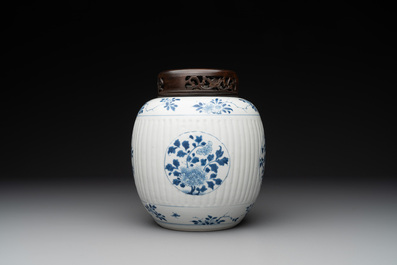 A Chinese blue and white jar with floral design and a wooden cover, Kangxi