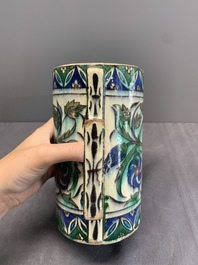 A polychrome Iznik-style mug with tulips and carnations, Kutahya, Turkey, 19th C.