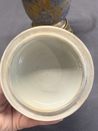 A Chinese gilt-ground blue and white lidded beaker on a French gilt bronze foot, Kangxi