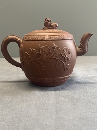 A Chinese Yixing stoneware teapot with relief design, Kangxi