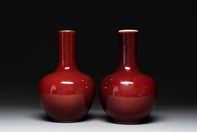 A Chinese apple-green-glazed and two copper-red-glazed bottle vases, Kangxi mark, 19/20th C.