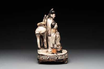 A rare Chinese Cizhou group with a dignitary, two attendants and a horse, Ming