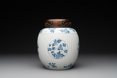 A Chinese blue and white jar with floral design and a wooden cover, Kangxi