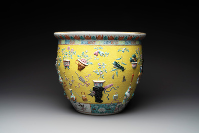 A Chinese famille rose yellow-ground relief-molded 'antiquities' fish bowl, Zhengde mark, 19th C.