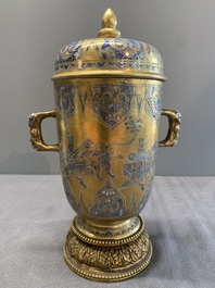 A Chinese gilt-ground blue and white lidded beaker on a French gilt bronze foot, Kangxi