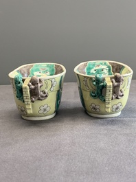 A pair of fine Chinese sancai-glazed 'Buddhist lion and chilong' libation cups, Kangxi