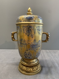 A Chinese gilt-ground blue and white lidded beaker on a French gilt bronze foot, Kangxi