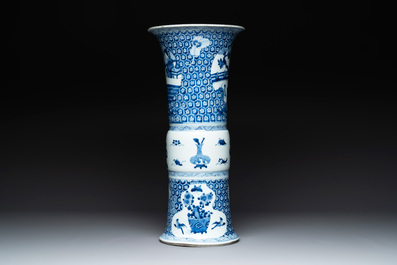 A Chinese blue and white 'gu' vase with a lady and antiquities, Kangxi