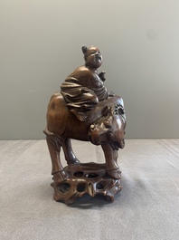 A pair of Chinese carved bamboo groups of a boy riding a buffalo, 19/20th C.