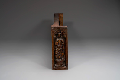 A carved front panel of a Gothic walnut chest with female saints, alcoves and rosettes, France, early 16th C.