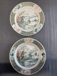 A pair of Chinese famille verte plates with figures along the riverside, artemisia leaf and ding mark, Kangxi