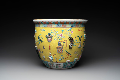 A Chinese famille rose yellow-ground relief-molded 'antiquities' fish bowl, Zhengde mark, 19th C.