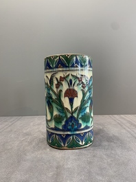 A polychrome Iznik-style mug with tulips and carnations, Kutahya, Turkey, 19th C.