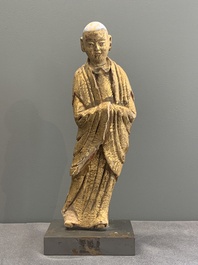A Chinese gilt and polychromed stucco figure of a monk, Ming