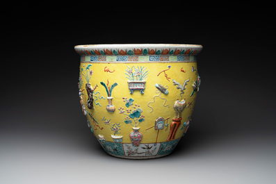 A Chinese famille rose yellow-ground relief-molded 'antiquities' fish bowl, Zhengde mark, 19th C.