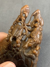 A rare Chinese carved rhinoceros horn 'libation cup' with grape design, 17/18th C.