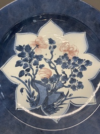 A Chinese blue, white and copper-red powder blue-ground 'peony' dish, Kangxi
