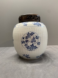 A Chinese blue and white jar with floral design and a wooden cover, Kangxi