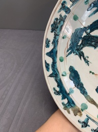 Two Chinese Swatow red-, turquoise- and black-enamelled 'phoenixes' and 'river landscape' dishes, Ming