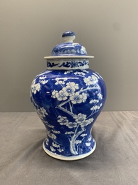 Two Chinese blue and white 'prunus on cracked ice' vases and covers, Kangxi mark, 19th C.