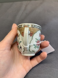 A fine Chinese famille rose armorial cup and two saucers, Yongzheng/Qianlong