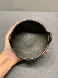A Chinese bronze tripod censer, Xuande mark, Ming