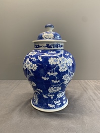 Two Chinese blue and white 'prunus on cracked ice' vases and covers, Kangxi mark, 19th C.