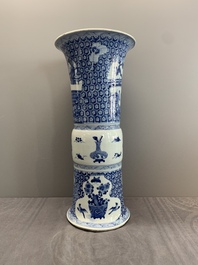 A Chinese blue and white 'gu' vase with a lady and antiquities, Kangxi