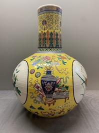 A large Chinese famille rose yellow-ground 'tianqiu ping' vase with flowers and antiquities, 19th C.