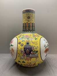 A large Chinese famille rose yellow-ground 'tianqiu ping' vase with flowers and antiquities, 19th C.
