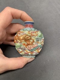 A Chinese famille rose molded 'Buddhist lions' and a grisaille 'dragon' snuff bottle, Qianlong and Daoguang mark, 19th C.