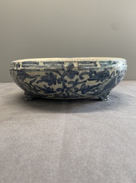 A Chinese Swatow blue and white crackle-glazed 'peonies and trigrams' tripod censer, Ming