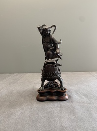 A rare Chinese bronze incense burner and cover in the shape of Liu Hai and a three legged toad, Ming