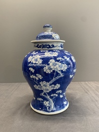 Two Chinese blue and white 'prunus on cracked ice' vases and covers, Kangxi mark, 19th C.