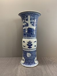 A Chinese blue and white 'gu' vase with a lady and antiquities, Kangxi
