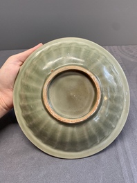 A Chinese Longquan celadon 'twin fish' dish and two 'twin fish' saucers, Yuan/Ming
