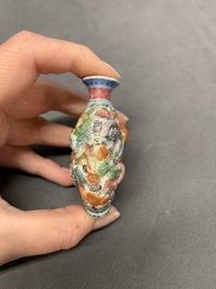 A Chinese famille rose molded 'Buddhist lions' and a grisaille 'dragon' snuff bottle, Qianlong and Daoguang mark, 19th C.