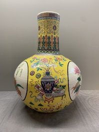 A large Chinese famille rose yellow-ground 'tianqiu ping' vase with flowers and antiquities, 19th C.