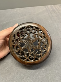 A Chinese blue and white jar with floral design and a wooden cover, Kangxi