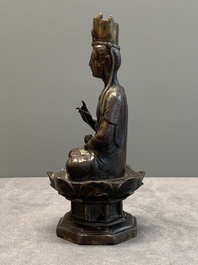 A Chinese bronze seated Guanyin on a lotus throne, probably Liao