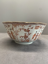A Chinese iron-red and gilt-decorated 'ladies in a garden' bowl, Kangxi