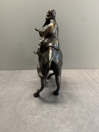 A Chinese gold-splashed bronze incense burner in the shape of an immortal riding a buffalo, 19th C.